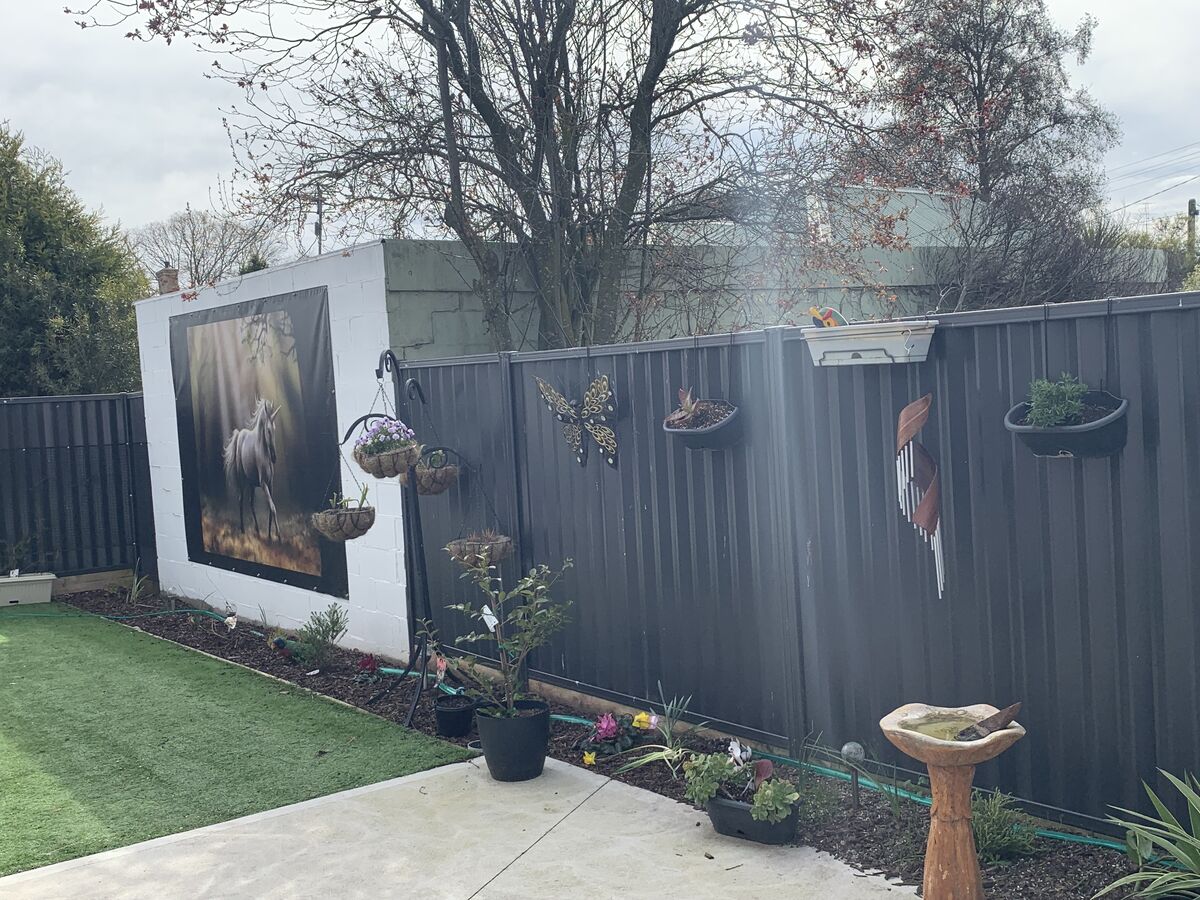 A unicorn mural takes pride of place on in one of the resident's personal outdoor areas.